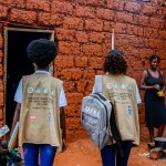The image depicts a rural setting with Tuberculosis awareness carried out by officers.