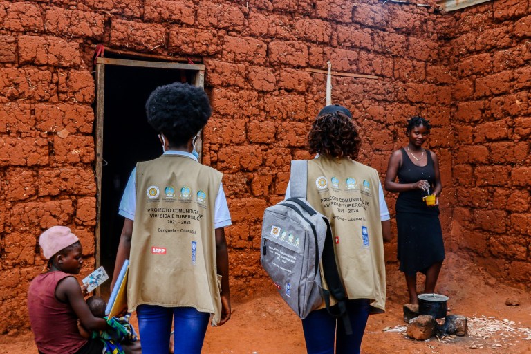 The image depicts a rural setting with Tuberculosis awareness carried out by officers.